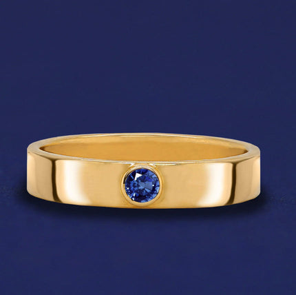 A Sapphire Gemstone Industrial Ring on a dark blue background