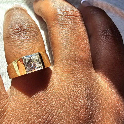 A custom large diamond ring set in a thick solid gold band