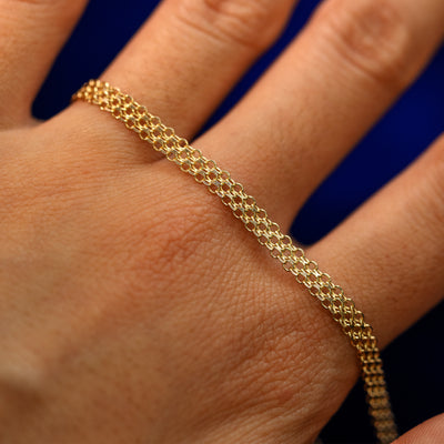 A yellow gold Bismark Chain Anklet on the back of a model's hand to show the details of the links