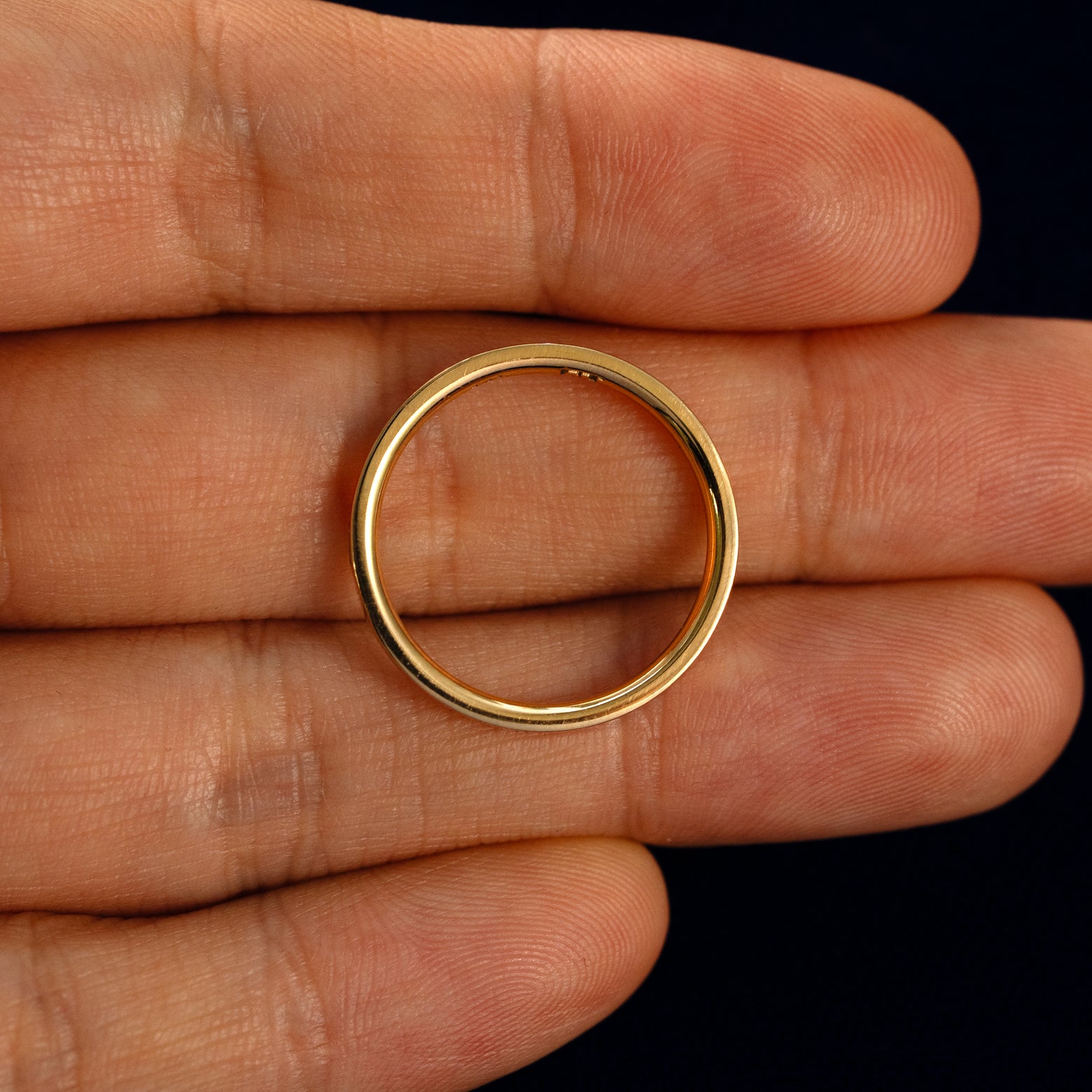 A Flush Set Baguette Diamond Ring in a model's hand showing the thickness of the band