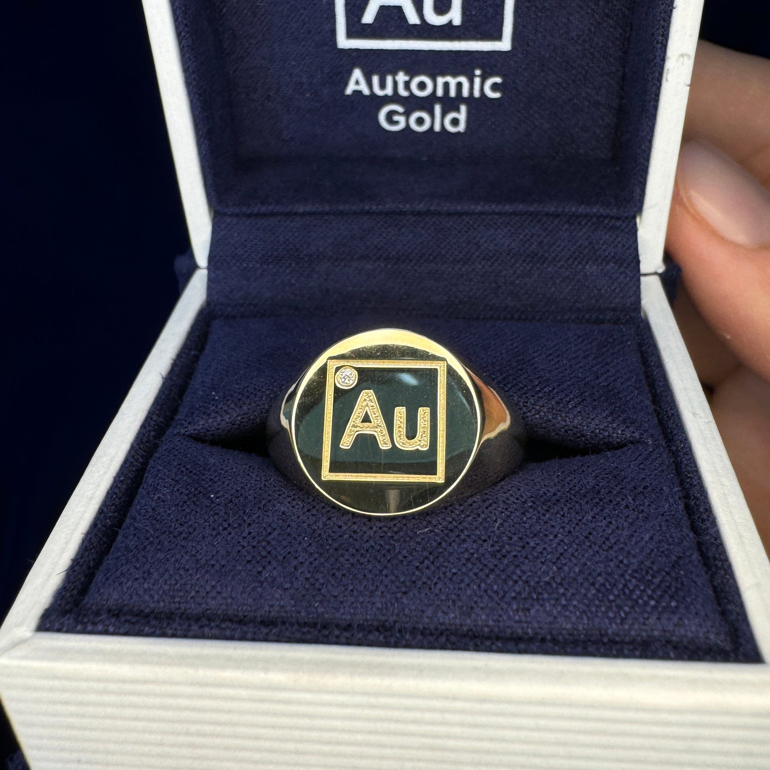 Yellow gold ring with AU engraving and round diamond