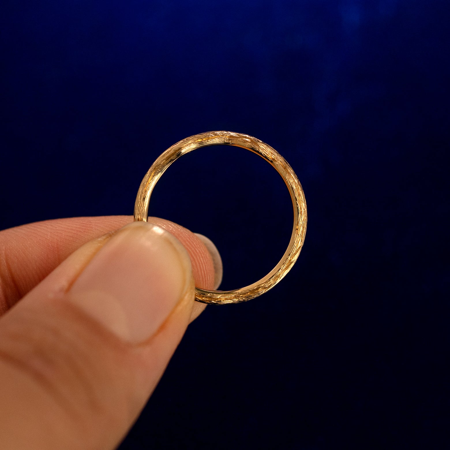 A model holding a Branch Band up to show the details of the side of the band