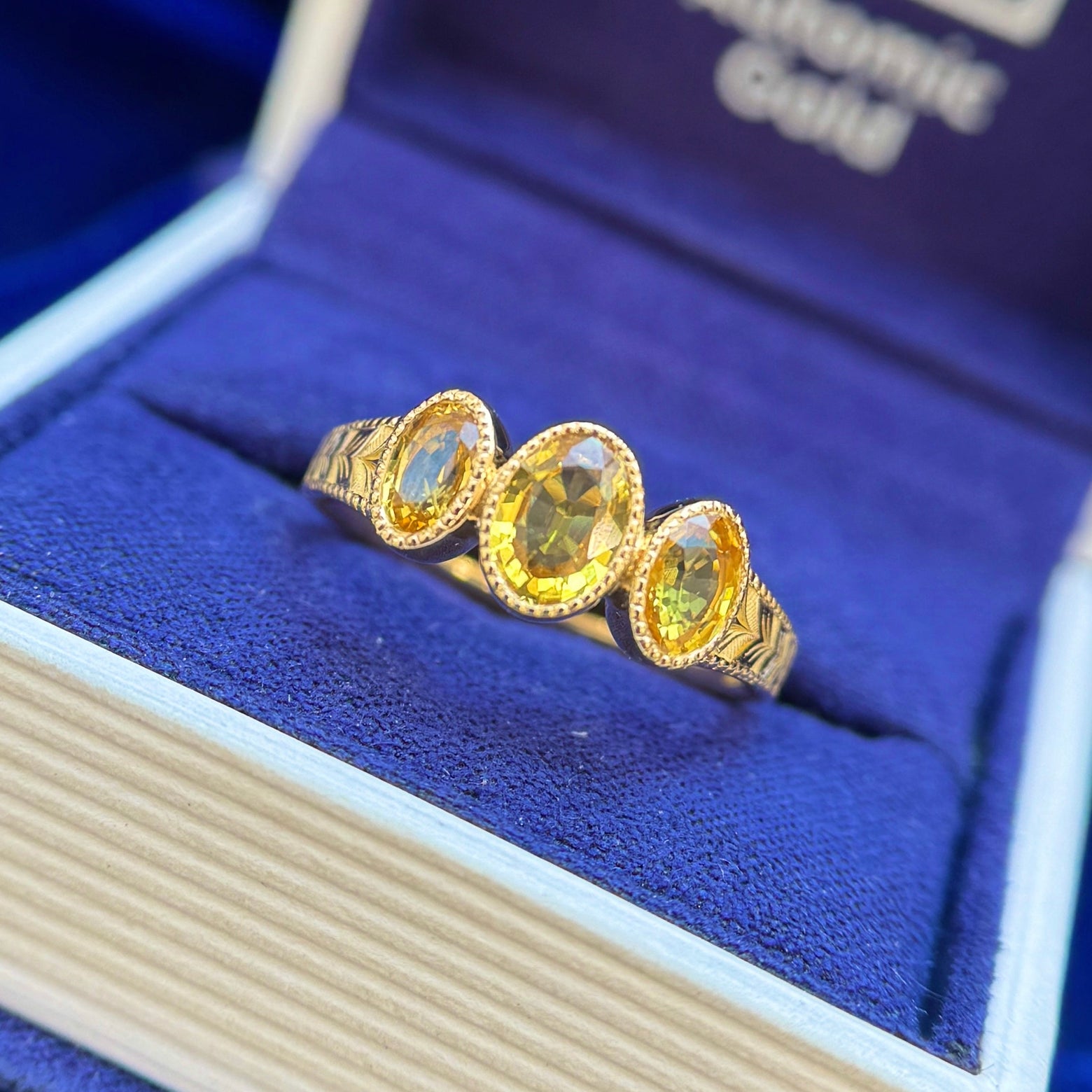 18k Yellow Gold and 2ctw Bezel-low-set 7x5mm with 2pc 6x4mm Oval Yellow Sapphires on Braided Band Custom Ring, size 8