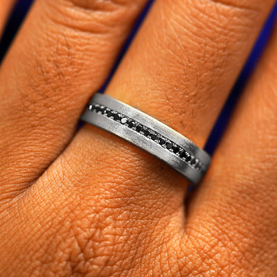 Close up view of a model's fingers wearing a 925 silver Endless Diamond Band