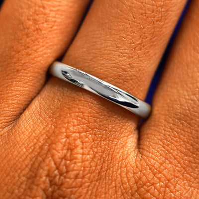 Close up view of a model's fingers wearing a 2mm 925 silver Curvy Mirror Band