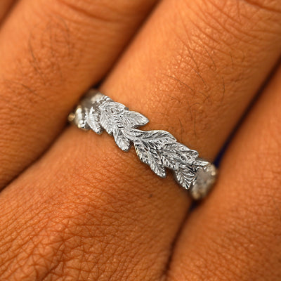 Close up view of a model's fingers wearing a 925 sterling silver Double Leaves Band