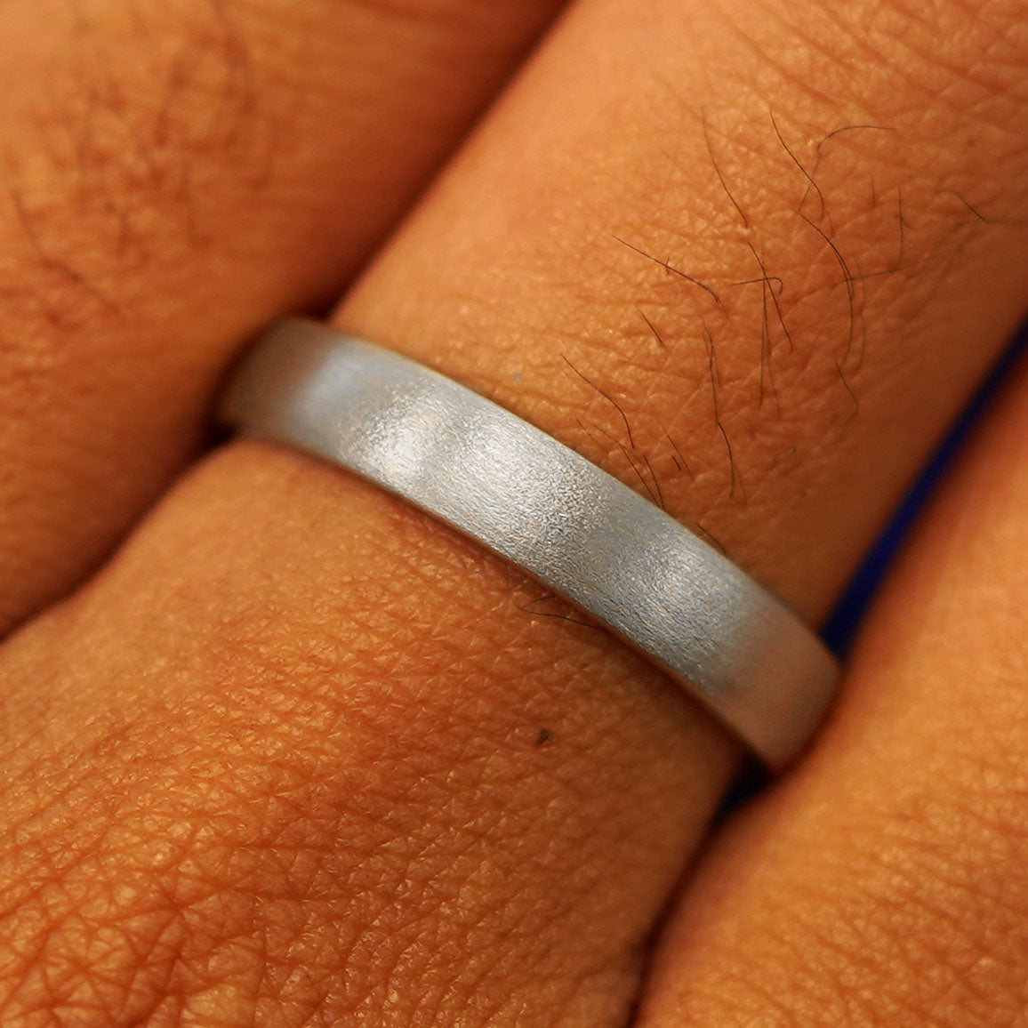 Close up view of a model's fingers wearing a Silver Mix Matte Band