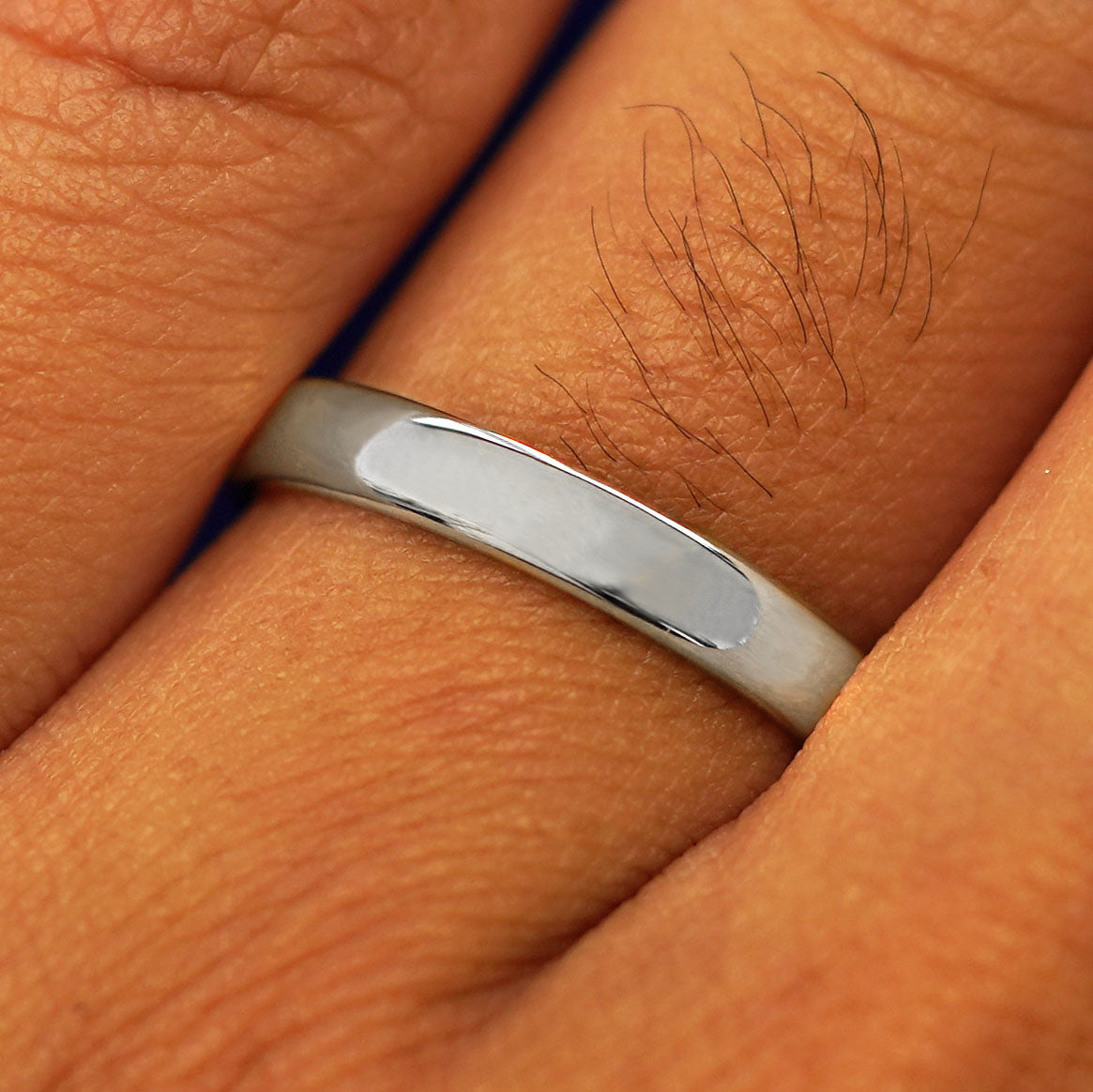 Close up view of a model's fingers wearing a Sterling Silver Mix Mirror Band