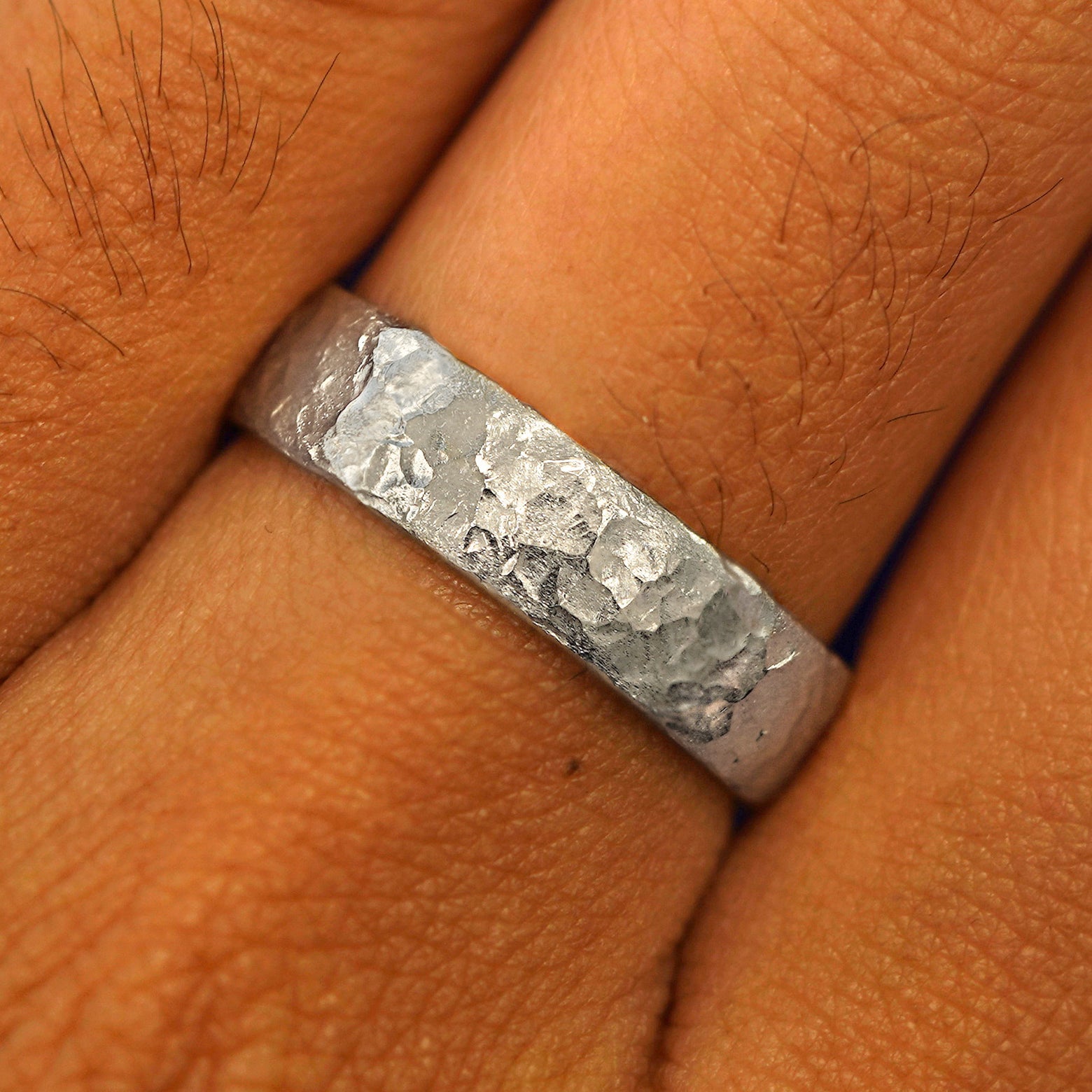 Close up view of a model's fingers wearing a Silver Mix Organic Band