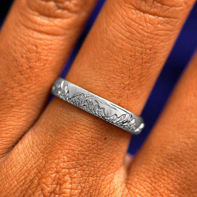 Close up view of a model's fingers wearing a 925 sterling silver Mountains Band