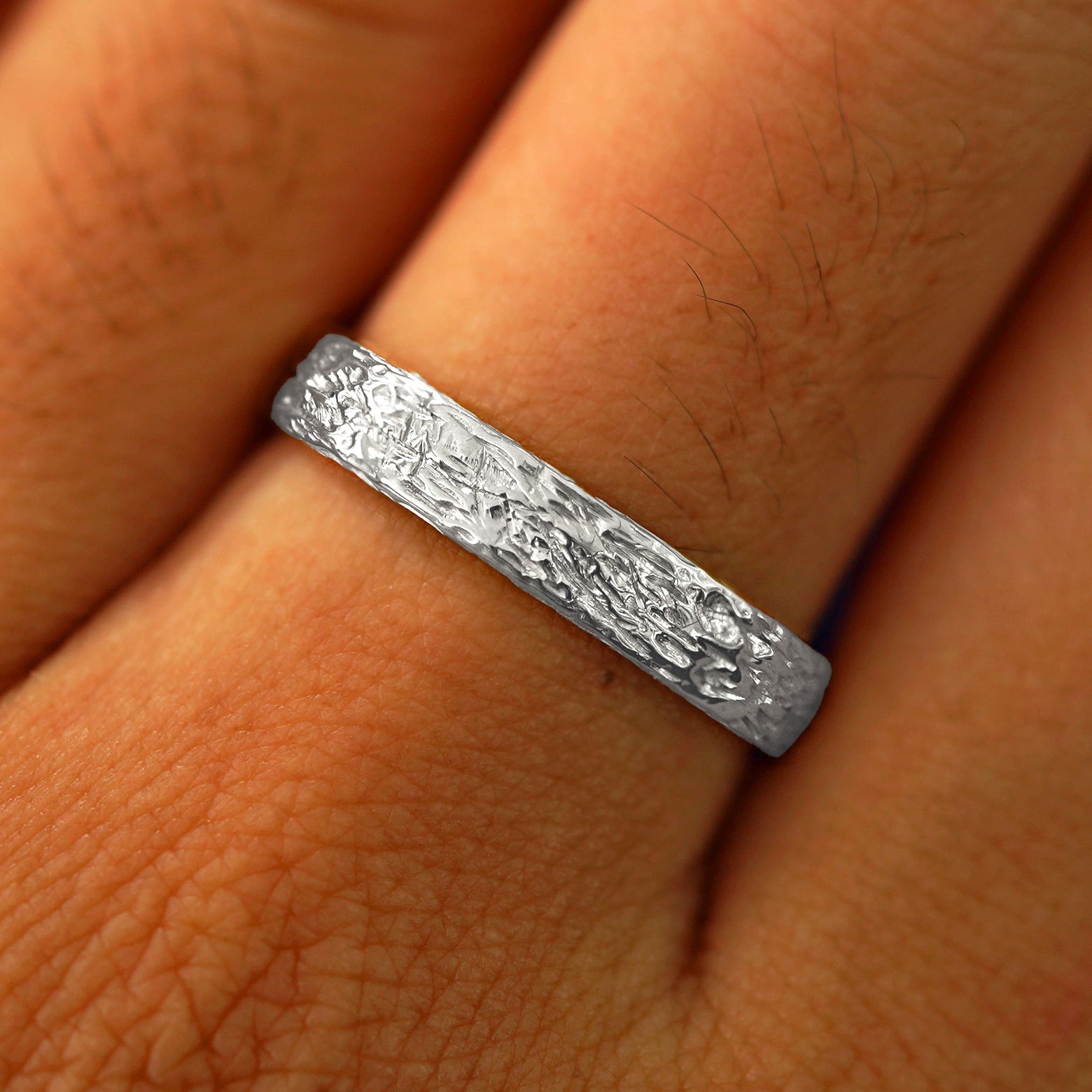 Close up view of a model's fingers wearing a 925 Silver Raw Band