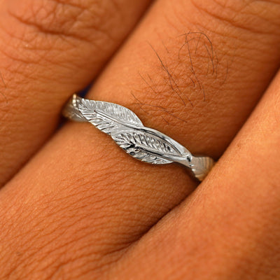 Close up view of a model's fingers wearing a 925 sterling silver Thick Leaves Band