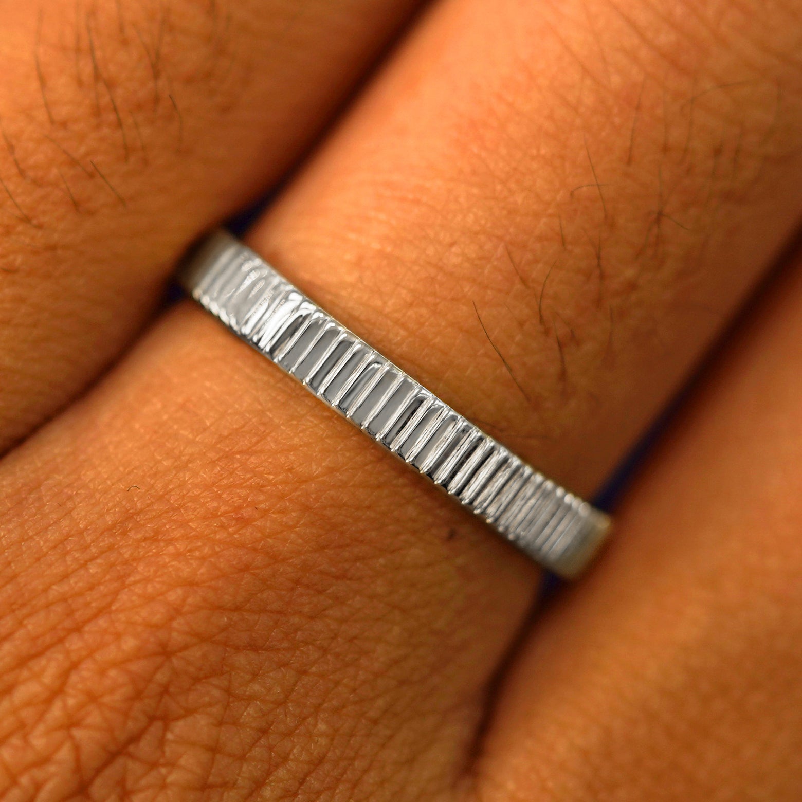 Close up view of a model's fingers wearing a 925 Silver Edge Band