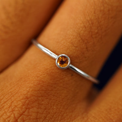 Close up view of a model's fingers wearing a 950 platinum Citrine Ring