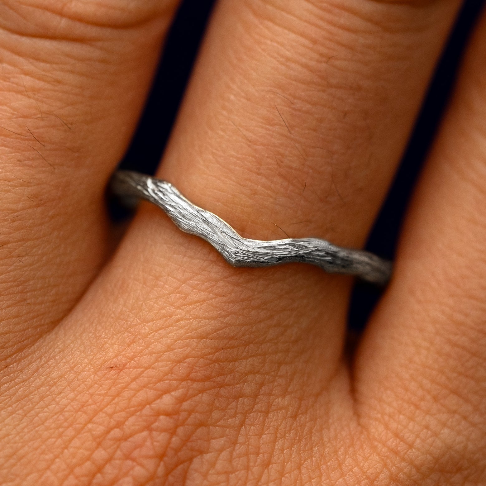 Close up view of a model's fingers wearing a 950 platinum Chevron Branches Band