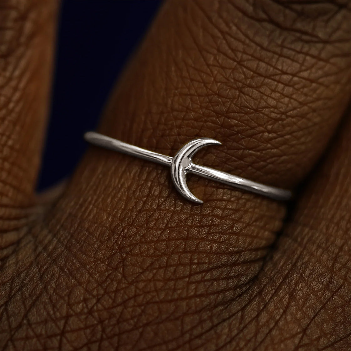 Close up view of a model's fingers wearing a 950 platinum Moon Ring