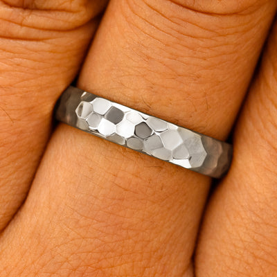 Close up view of a model's fingers wearing a platinum Curvy Hammered Band