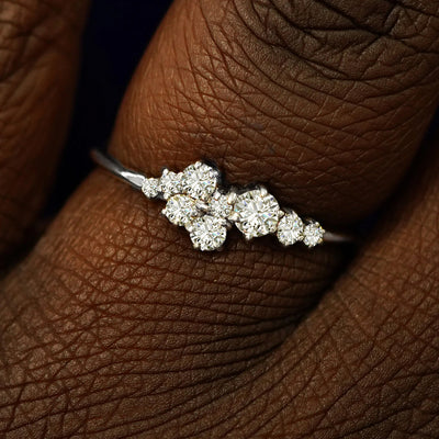 Close up view of a model's fingers wearing a 950 platinum Diamond Cluster Ring