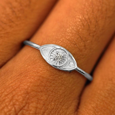 Close up view of a model's hand wearing a platinum Diamond Evil Eye Ring