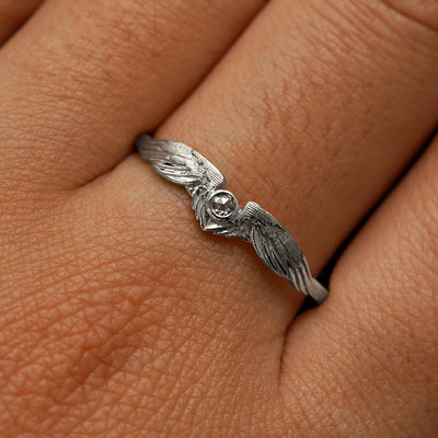 Close up view of a model's fingers wearing a 950 platinum Diamond Wings Ring