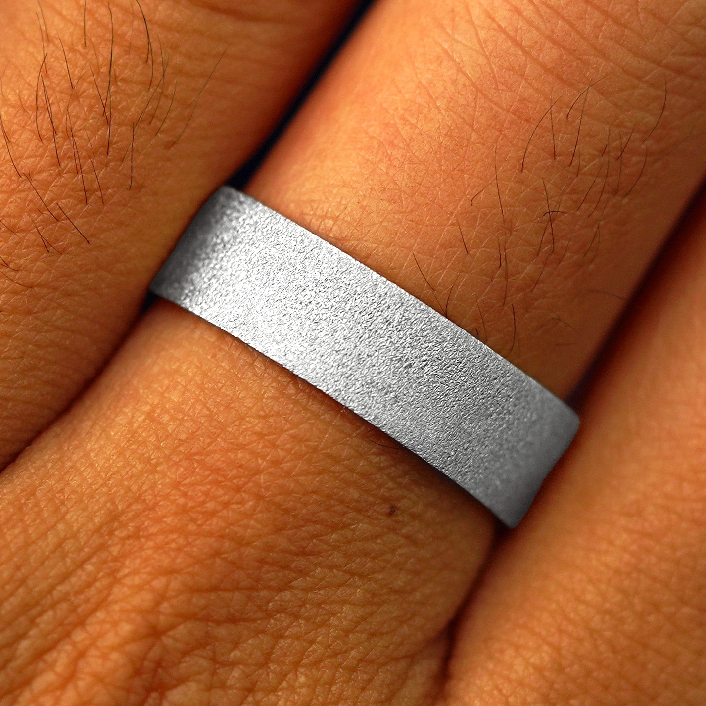 Close up view of a model's fingers wearing a 950 Platinum Industrial Stardust Band