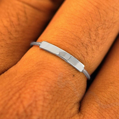 Close up view of a model's fingers wearing a platinum Bar Ring