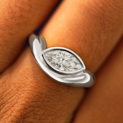 Close up view of a model's fingers wearing a 950 platinum Marquise Lab Diamond Melted Ring