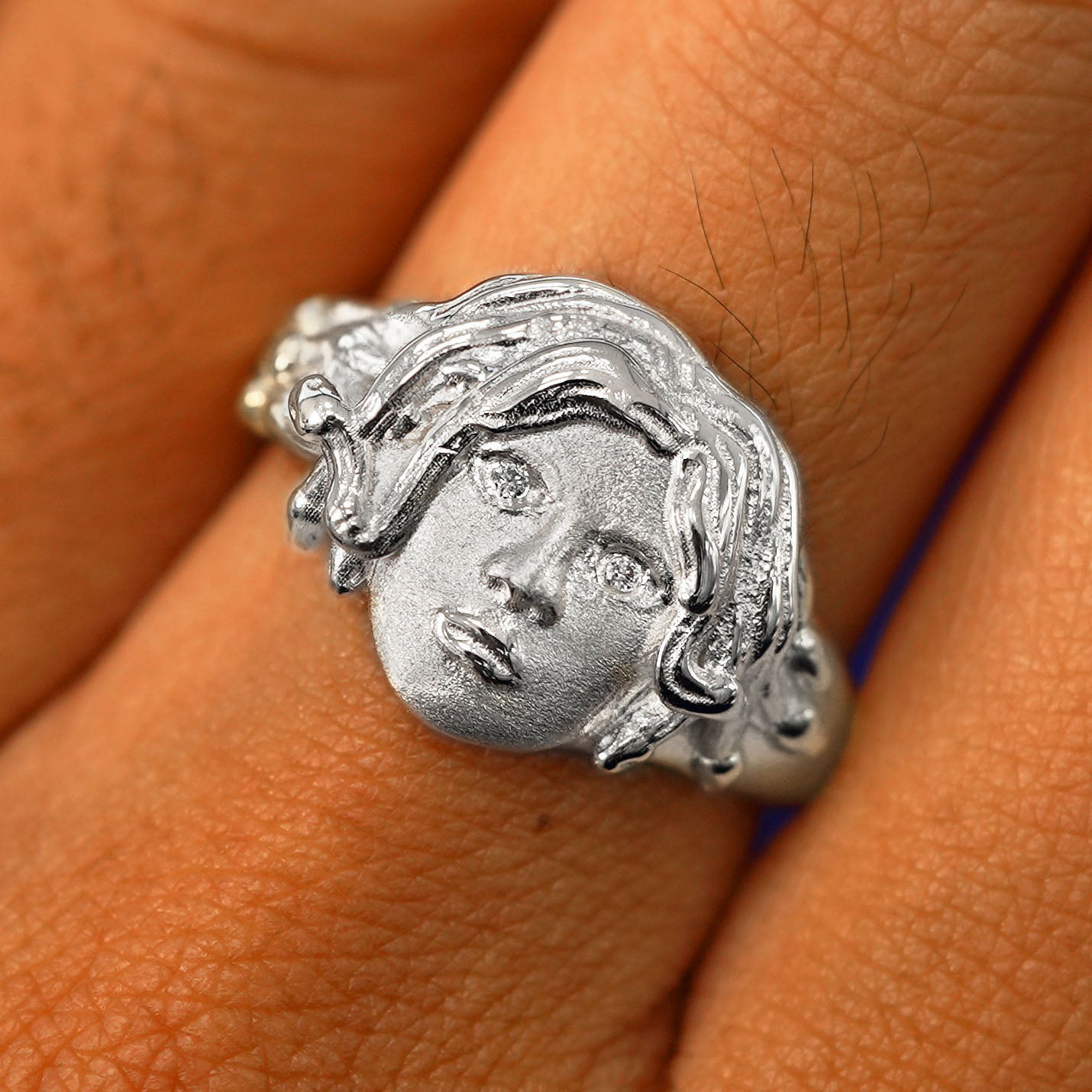 Close up view of a model's fingers wearing a 950 platinum Medusa Ring