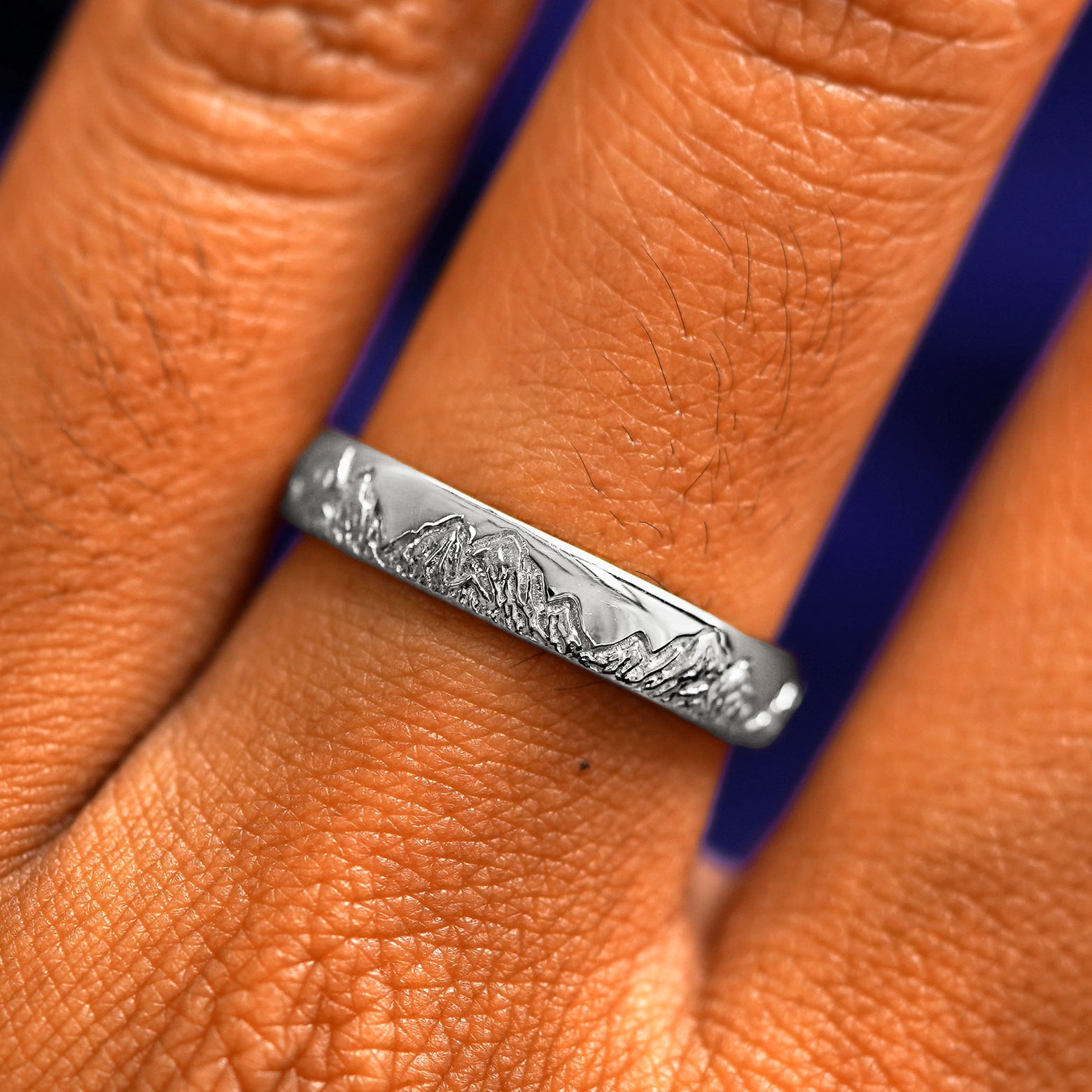 Close up view of a model's fingers wearing a 950 platinum Mountains Band