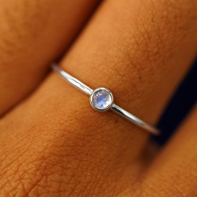 Close up view of a model's fingers wearing a 950 platinum Moonstone Ring
