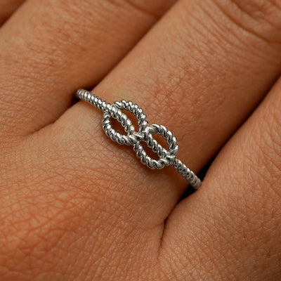 Close up view of a model's fingers wearing a 950 platinum Rope Infinity Ring