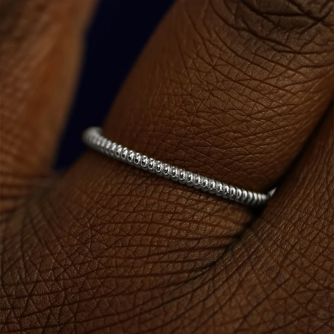 Close up view of a model's fingers wearing a 950 platinum Rope Ring