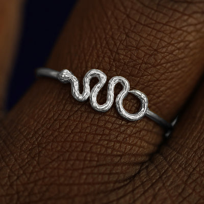 Close up view of a model's fingers wearing a 950 platinum Snake Ring