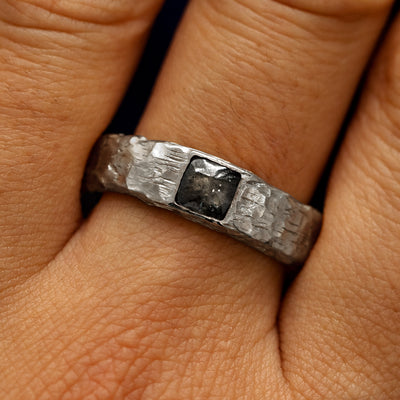 Close up view of a models fingers wearing a 950 platinum Square Diamond Organic Band