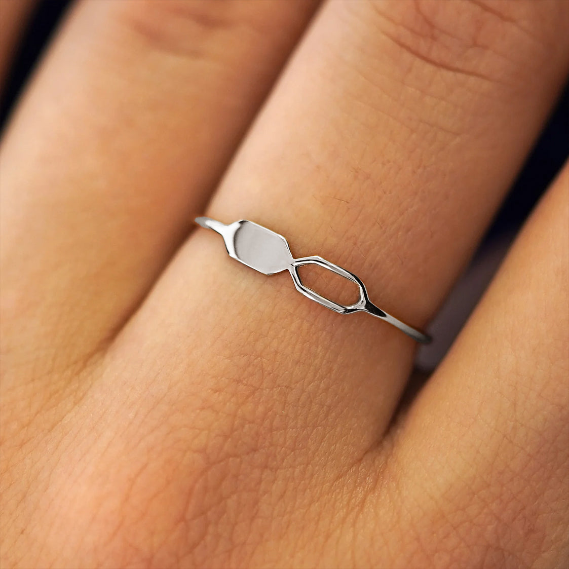 Close up view of a model's fingers wearing a 950 platinum Tanlah Ring