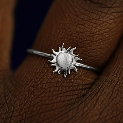 Close up view of a model's fingers wearing a 950 platinum Sun Ring