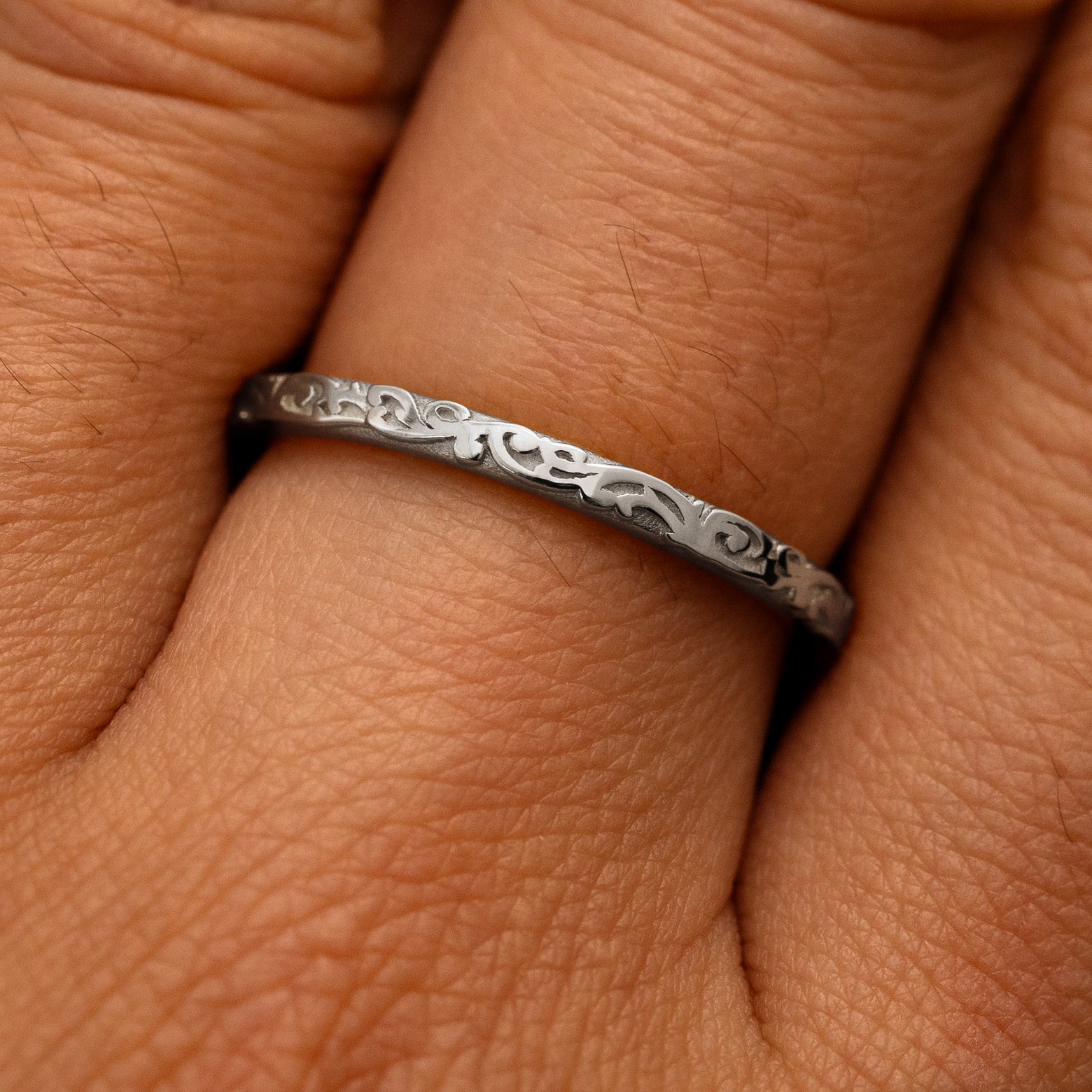 Close up view of a model's fingers wearing a 950 platinum Thin Filigree Band