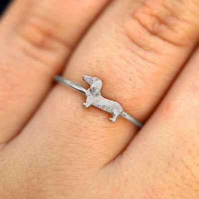 Close up view of a model's fingers wearing a 950 platinum Dog Ring