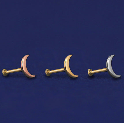 Three Moon Flatbacks shown in options of rose, yellow, and white gold on a dark blue background