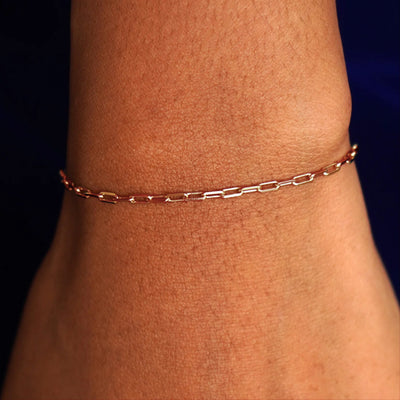 Close up view of a model's wrist wearing a solid rose gold Butch Bracelet