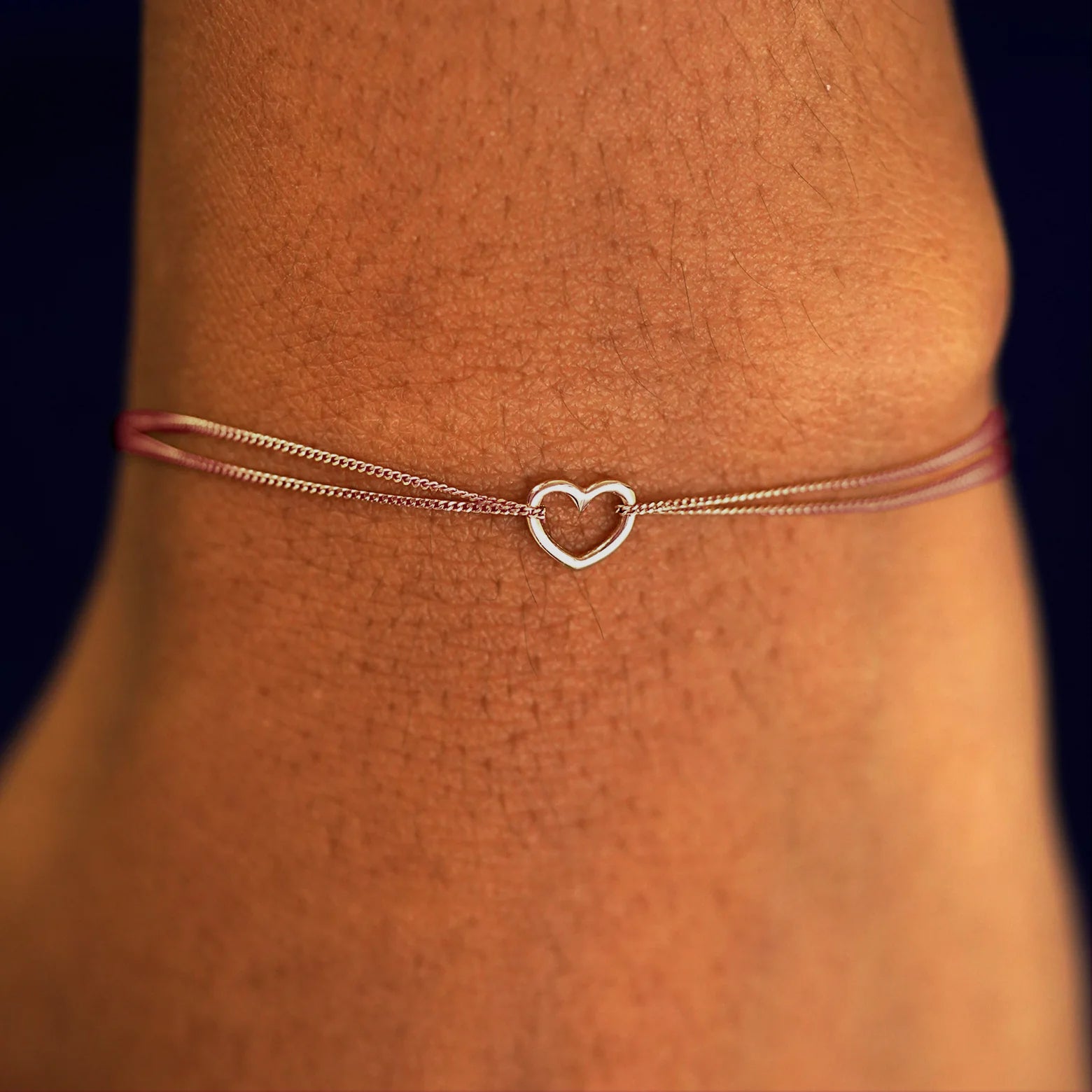 A model's wrist wearing a solid rose gold Heart 
