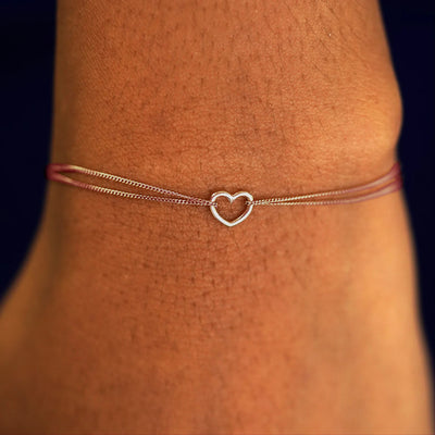 A model's wrist wearing a solid rose gold Heart 