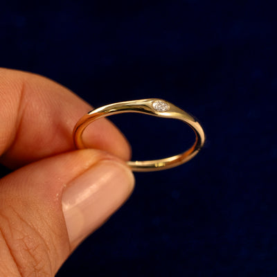 A model holding a Flush Set Oval Diamond Ring tilted to show the details of the ring
