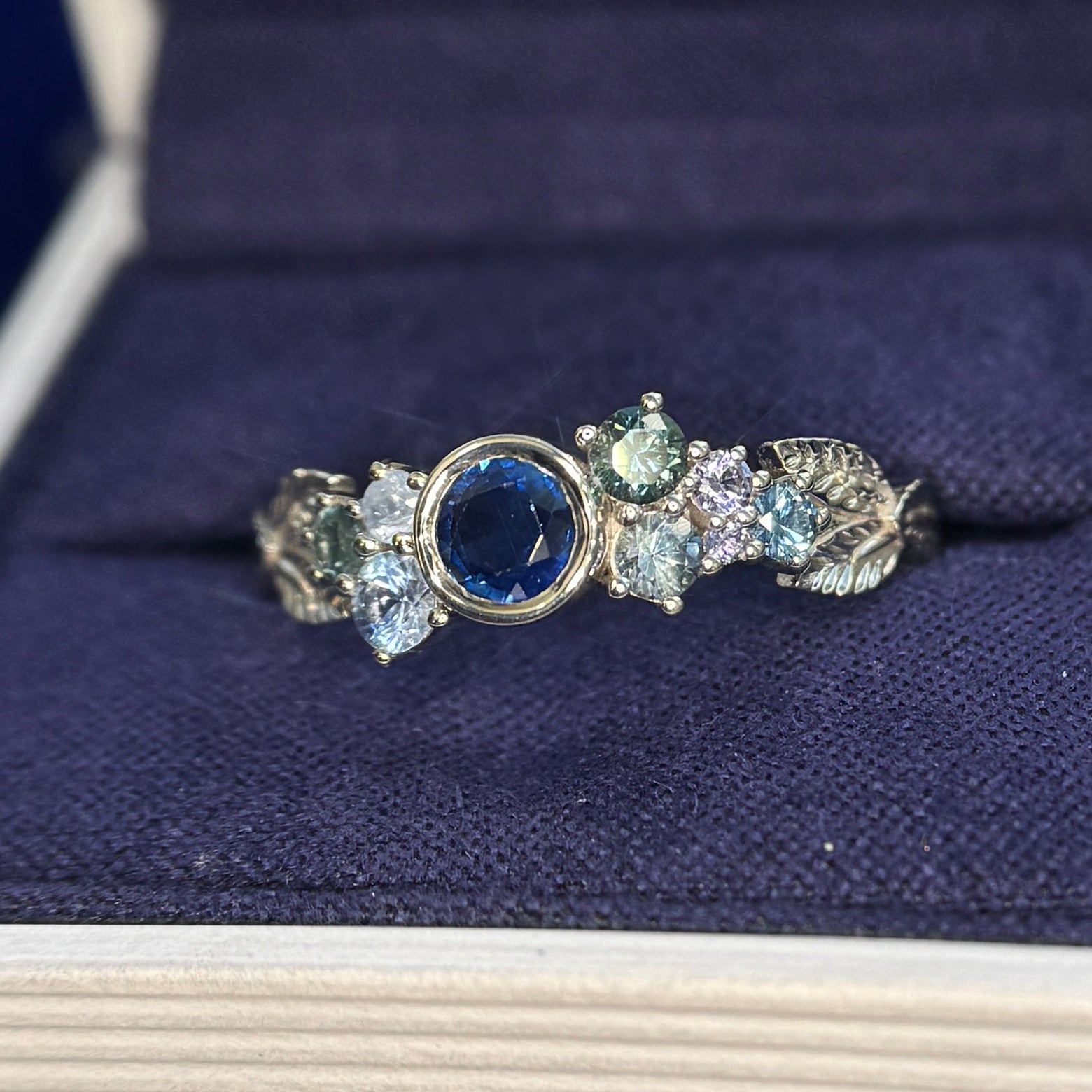 14k Champagne Gold and Bezel-set all gems with 5mm Round Blue Sapphire and Cluster of Light Purple, Blue, Teal Sapphires with 3 Leaves Custom Cluster Ring
