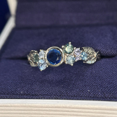 14k Champagne Gold and Bezel-set all gems with 5mm Round Blue Sapphire and Cluster of Light Purple, Blue, Teal Sapphires with 3 Leaves Custom Cluster Ring