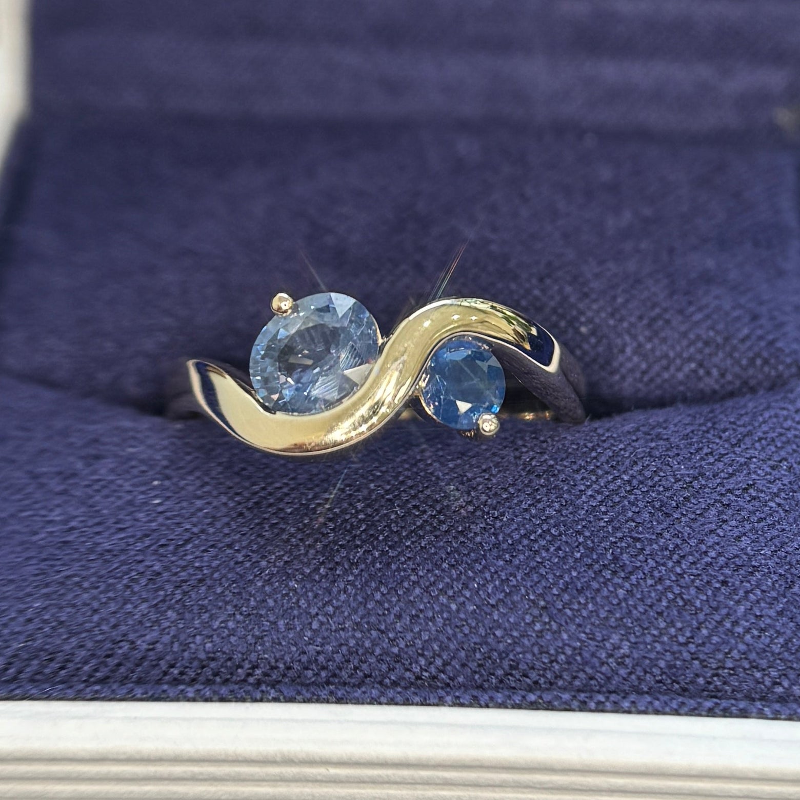 14k Yellow Gold with 0.73ct Light Blue Oval and 0.18ct Blue Round Sapphire set on 2.7mm Wavy Band Tapered to 3.7mm on the back Custom Ring, size 6.75