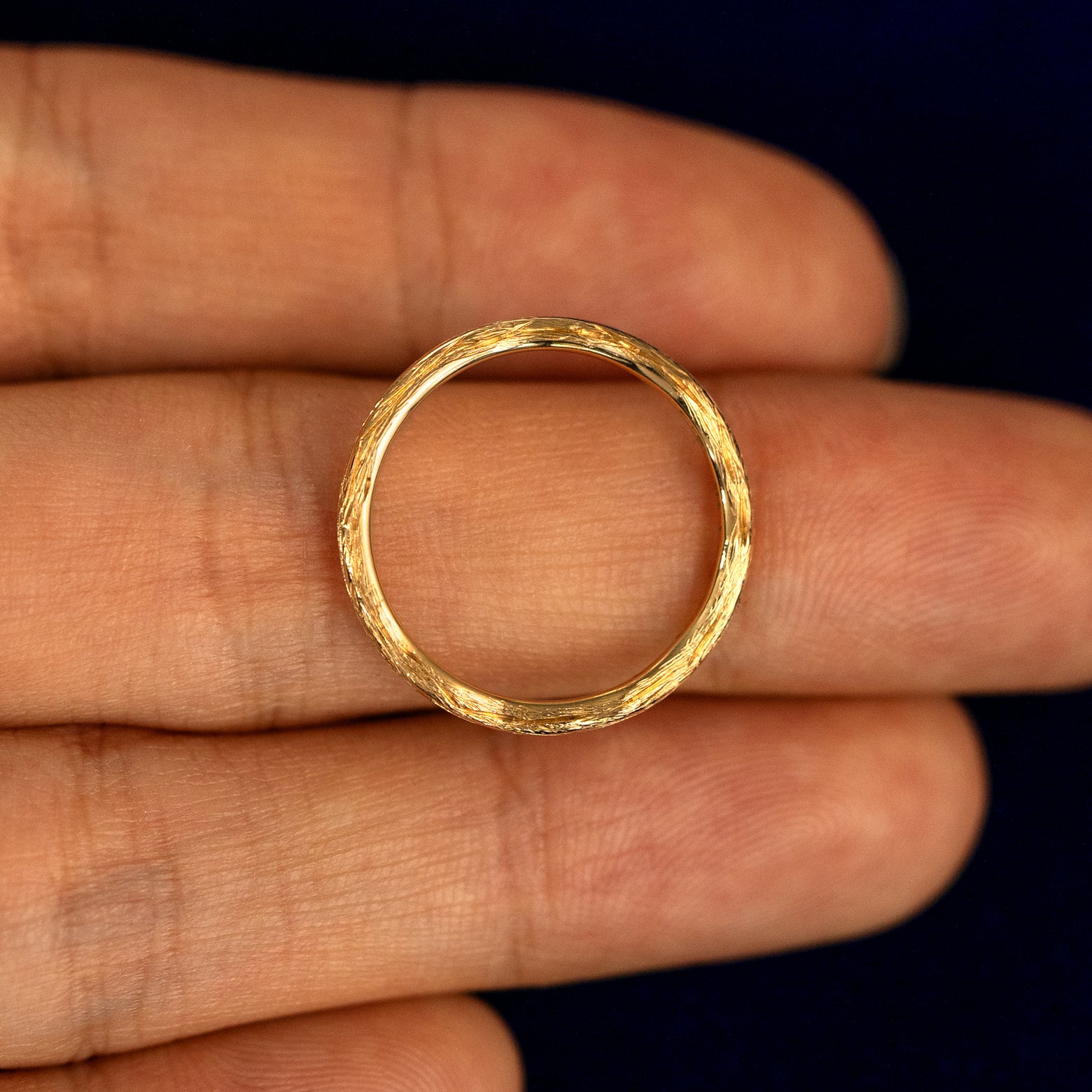 A Branch Band lying flat in a models hand to show the thickness of the Ring