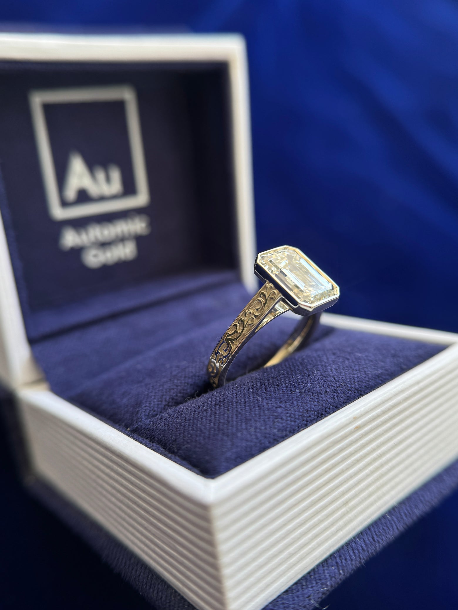 side view of 14k Champagne Gold Cathedral-bezel-set 3ct Emerald Cut Lab Diamond on 3mm Industrial Filigree Band Custom Ring, Size 6