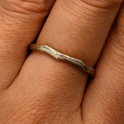 Close up view of a model's fingers wearing a 14k champagne gold Branch Band