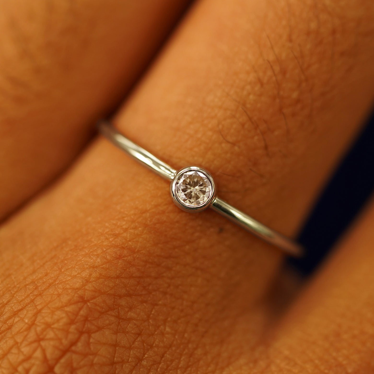 Close up view of a model's fingers wearing a 14k champagne gold Champagne Diamond Ring